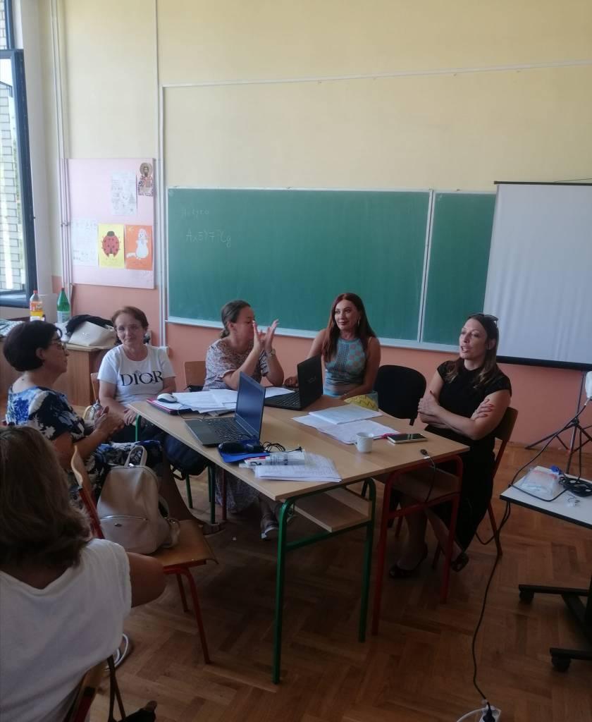 A group of people sitting around a table

Description automatically generated