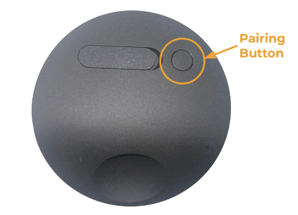 An image of the back of the Wireless Outdoor Security Camera with an arrow pointing to its pairing button - a small circular button.