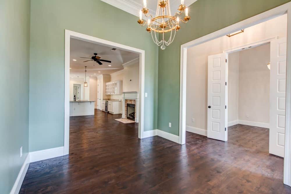 Across the flex room is the study enclosed in white double doors.