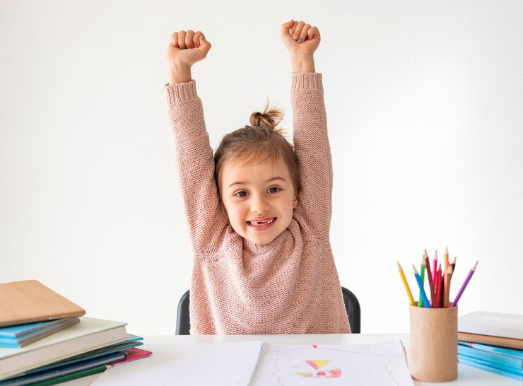 a child with her arms in the air