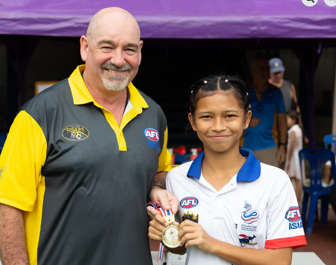A person and a child holding a medal

AI-generated content may be incorrect.