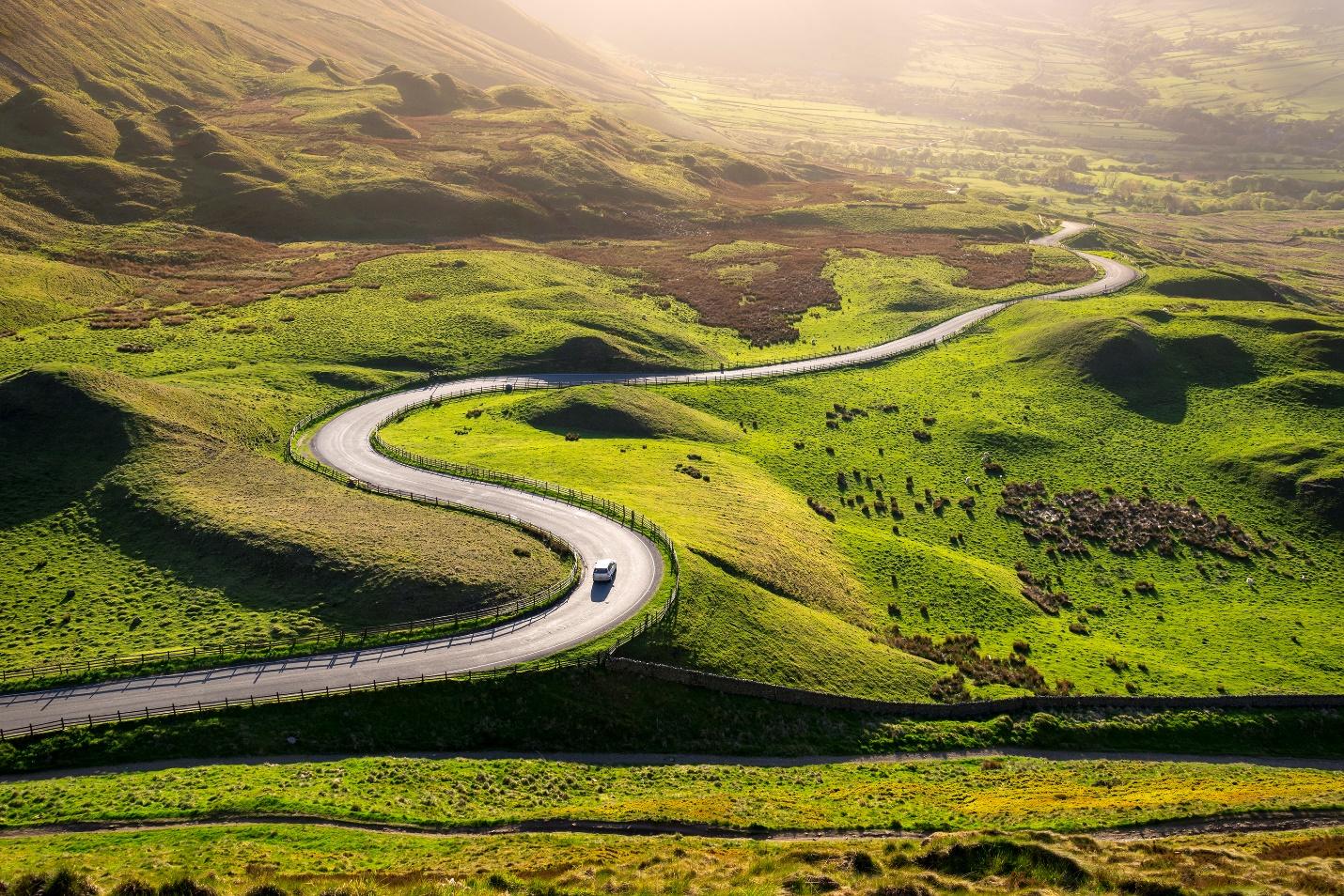 Car driving in the hills on a sunny day