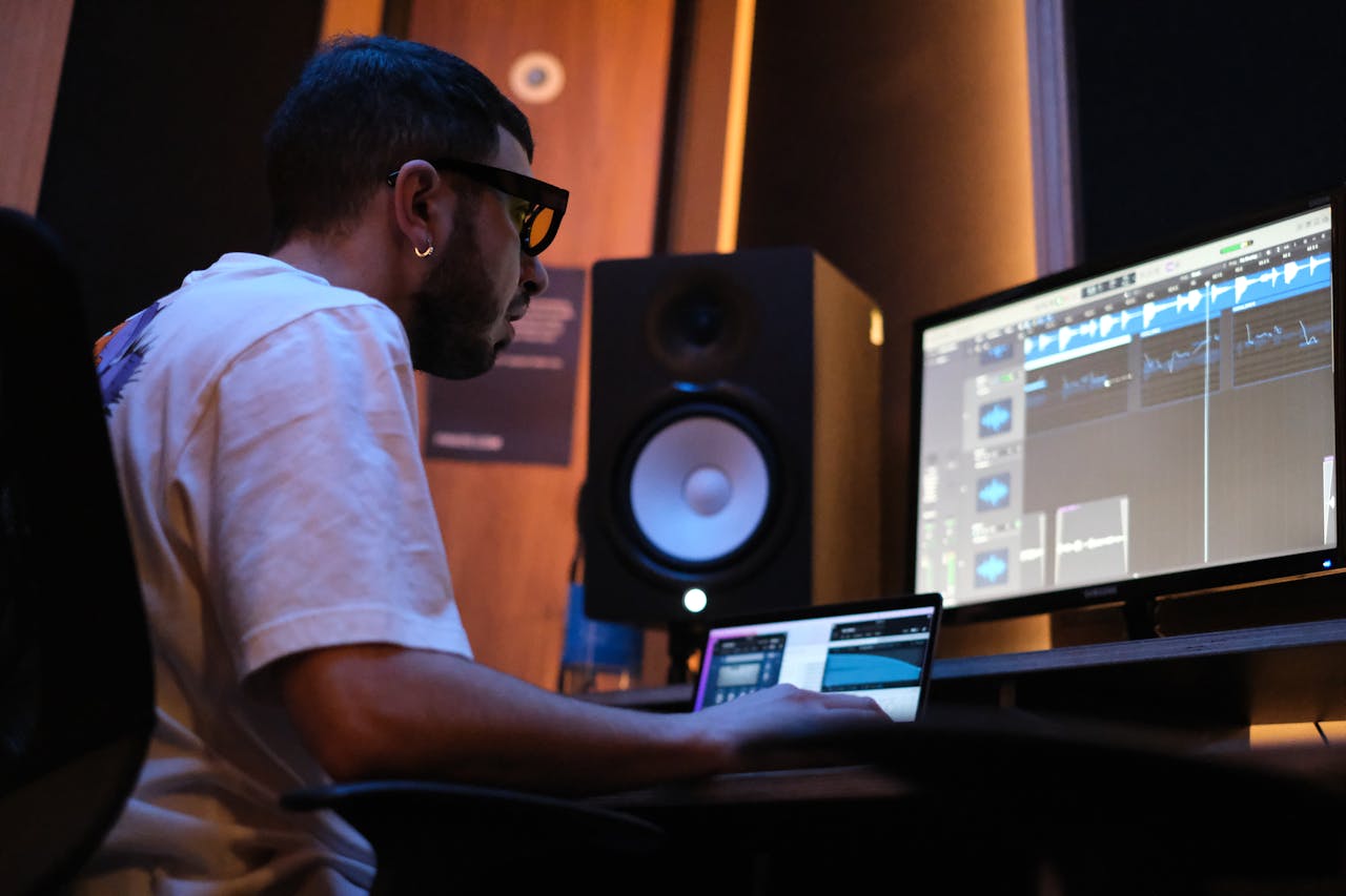 A music producer focused on his computer screen