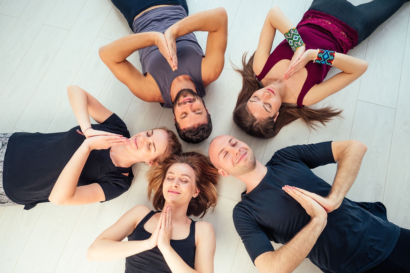 A group of yogis practice breathing exercises.