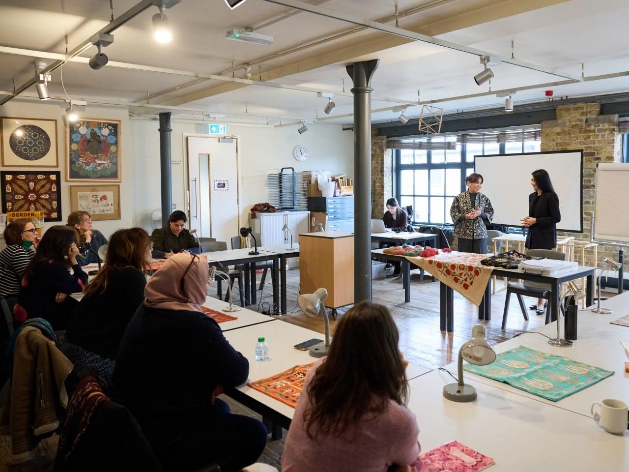A group of people sitting at tables in a room

Description automatically generated