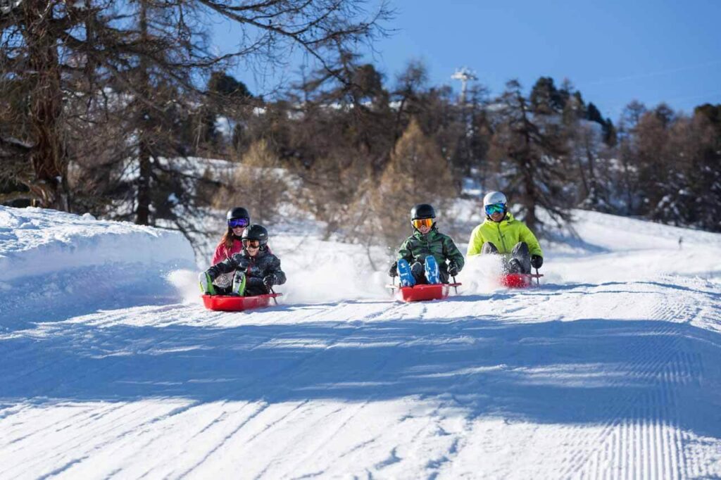 children tobogganing in the winter