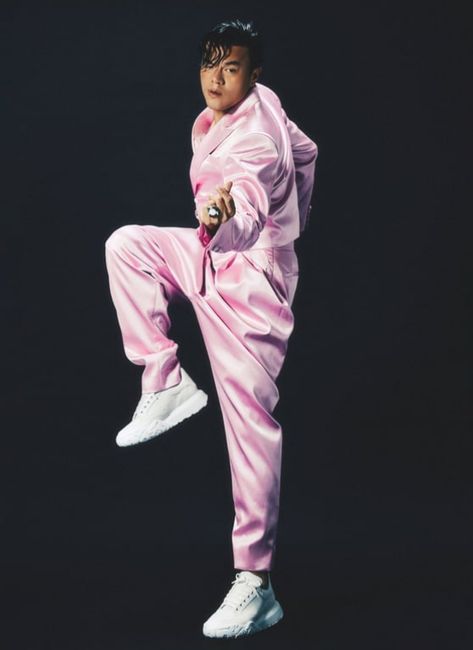 This contain J.Y. Park  in pink jumps while holding a tennis racquet and wearing white sneakers