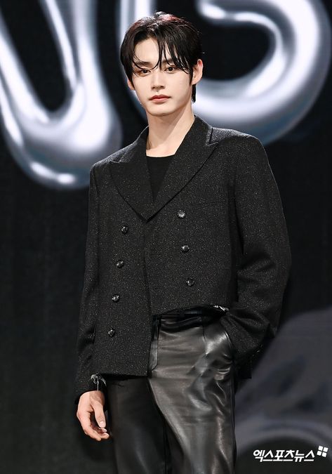 This contain of Kim Jiwoong black hair model in a black jacket and leather pants on the catwalk at a fashion show