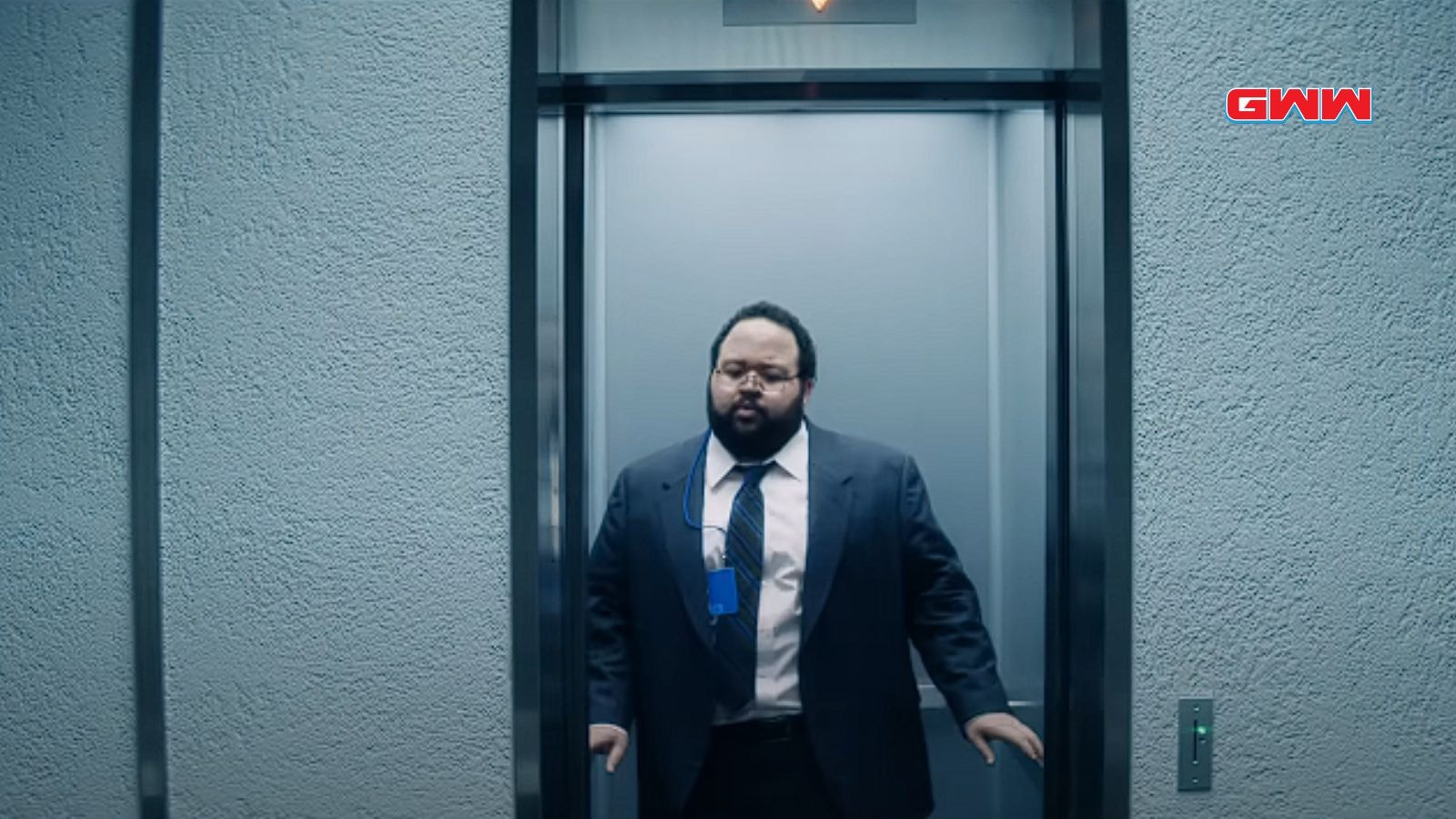 Character Dylan in a suit standing in an elevator, looking serious