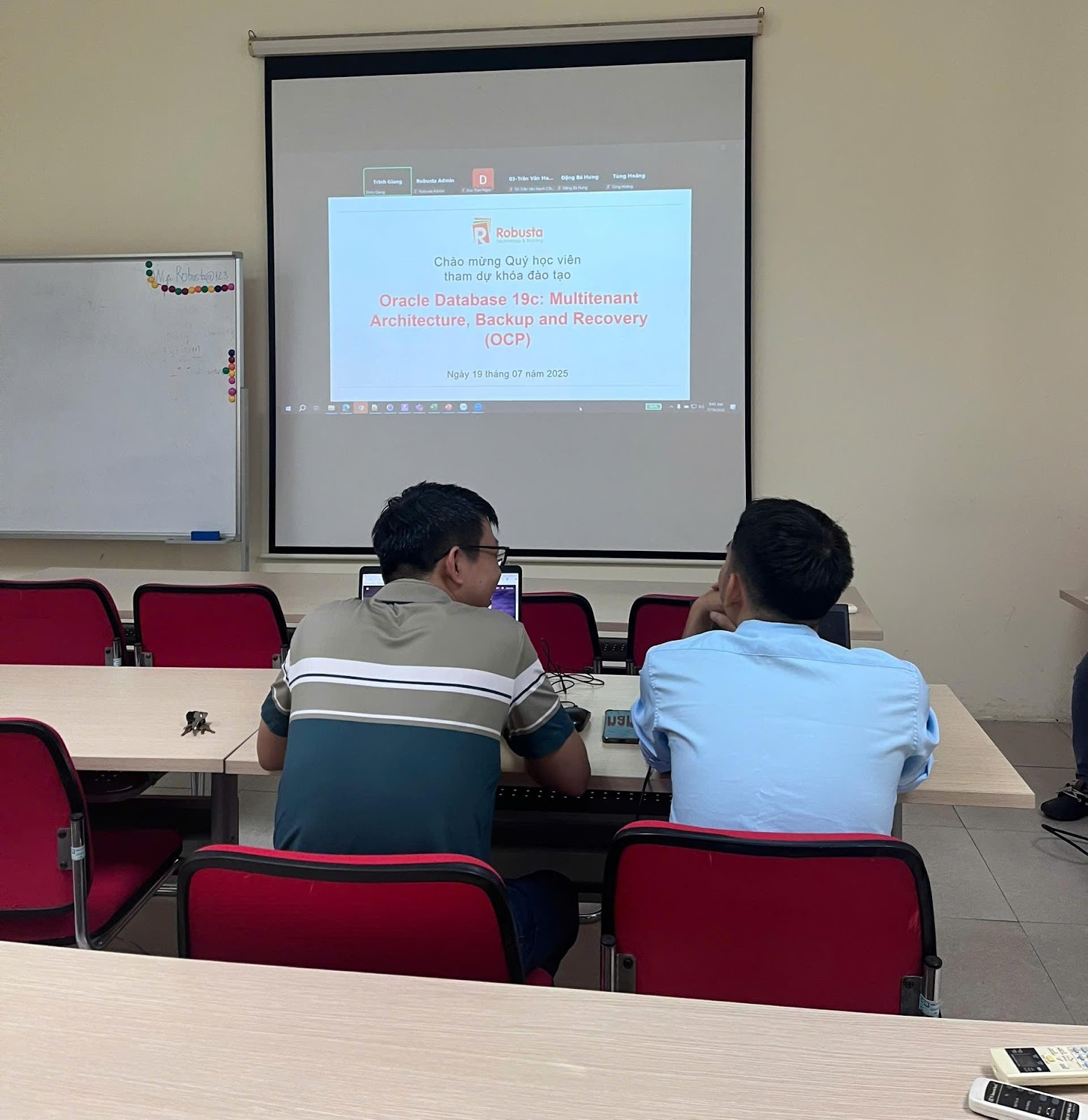 A group of people sitting at a desk in front of a projector screen

AI-generated content may be incorrect.