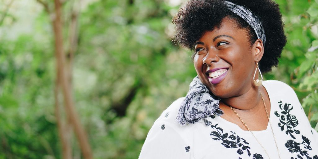 smiling woman looking on right side during daytime