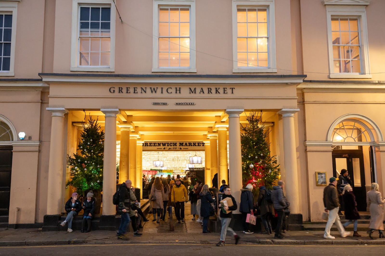 Greenwich Christmas Market in London with festive stalls, unique gifts, twinkling lights, and visitors enjoying seasonal food and holiday shopping.