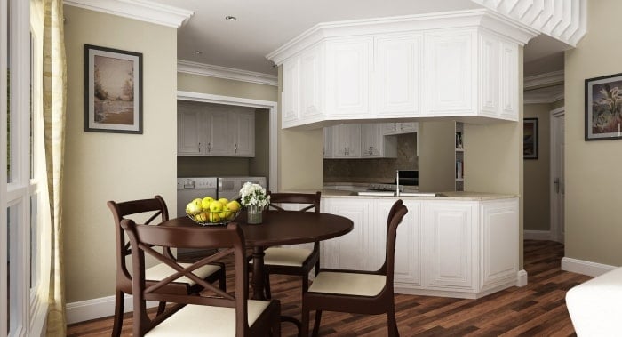The eat-in kitchen is equipped with a round dining set, white cabinetry, and plenty of counter space.