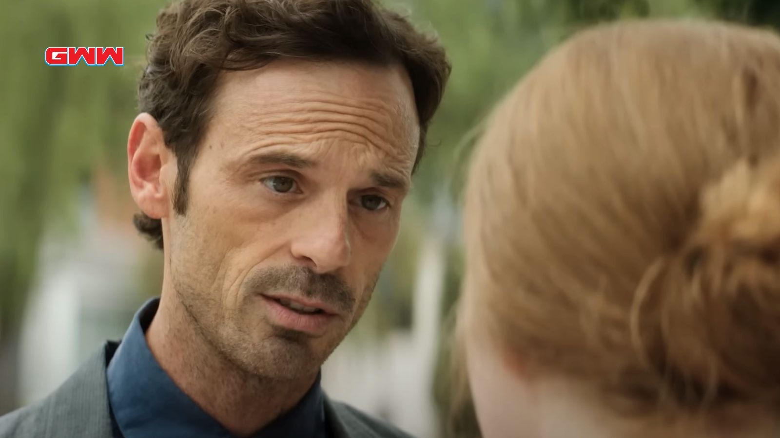 Scoot McNairy’s character having a serious conversation outdoors.