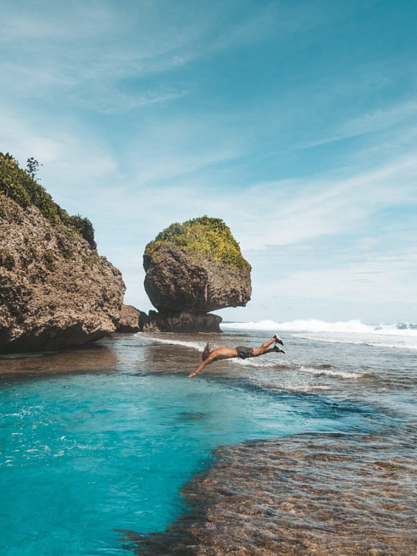 A traveler taking a dive in Magpupungko Rock Pools