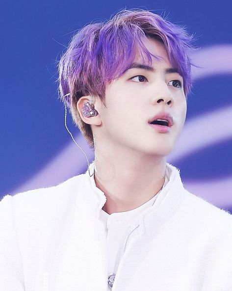 This contain an image of Jin on a purple hair putting on a white dress