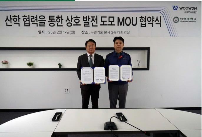 Two men holding signs in front of a sign

AI-generated content may be incorrect.