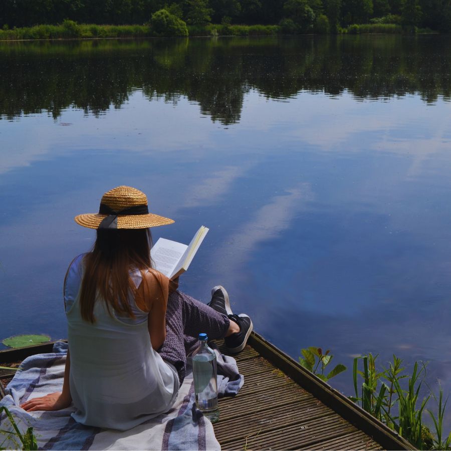 woman reading at lake