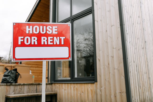 House for rent sign in front of building