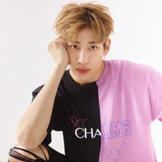 This contains an image of  BamBam's in a black and pink t - shirt with the word charm on it