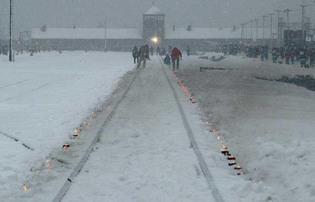 Candles mark the railway tracks leading to the Auschwitz camp during the commemoration of the 60th anniversary of the liberation ...