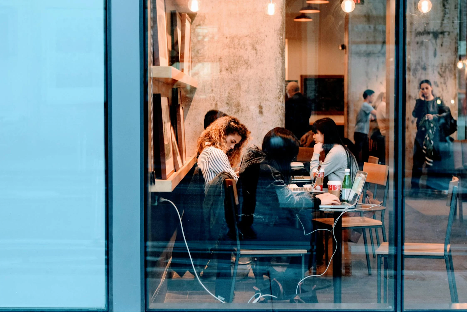 People co-working on laptops in a cafe