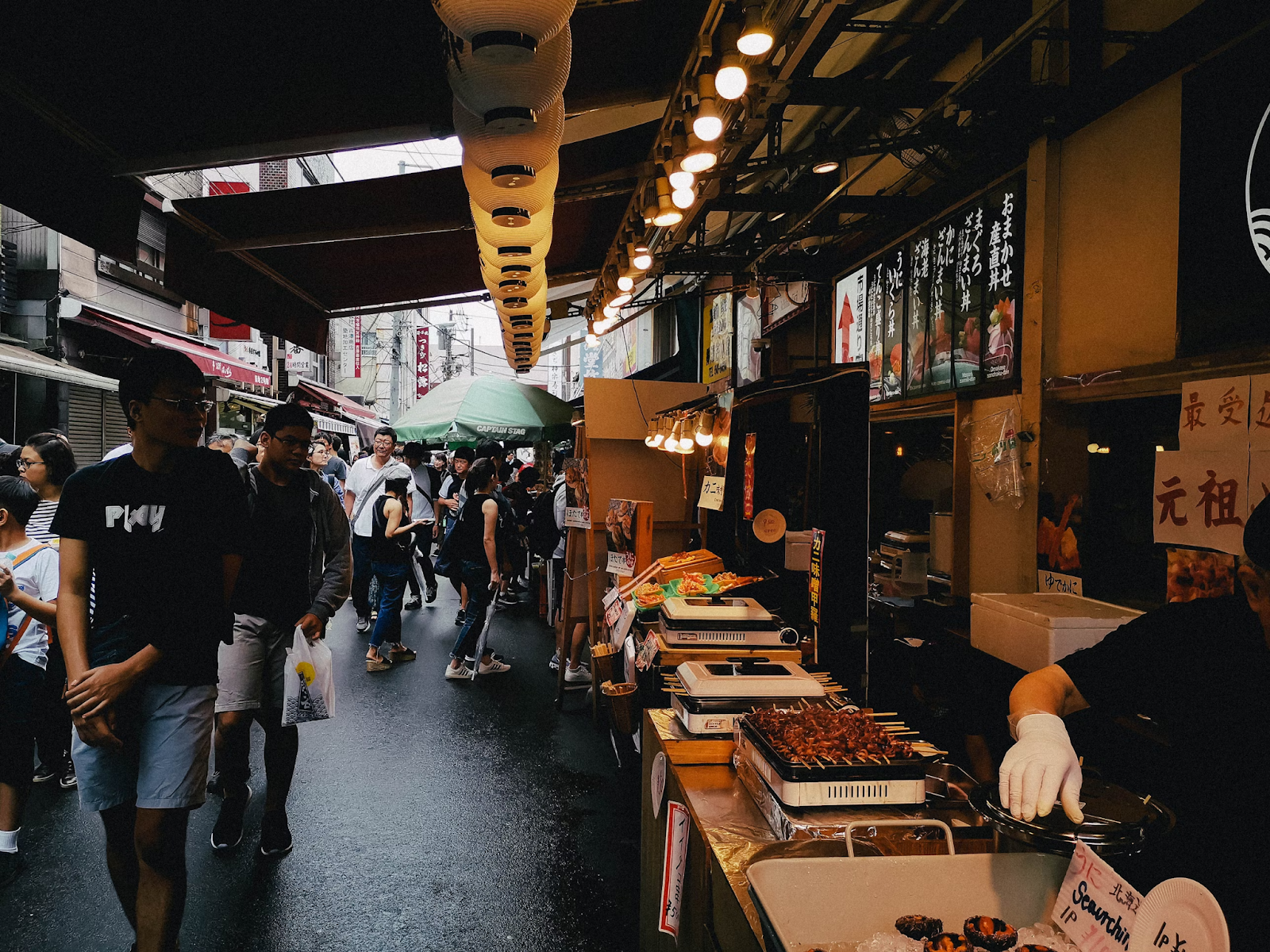 A bustling fish market with fresh seafood on sale.