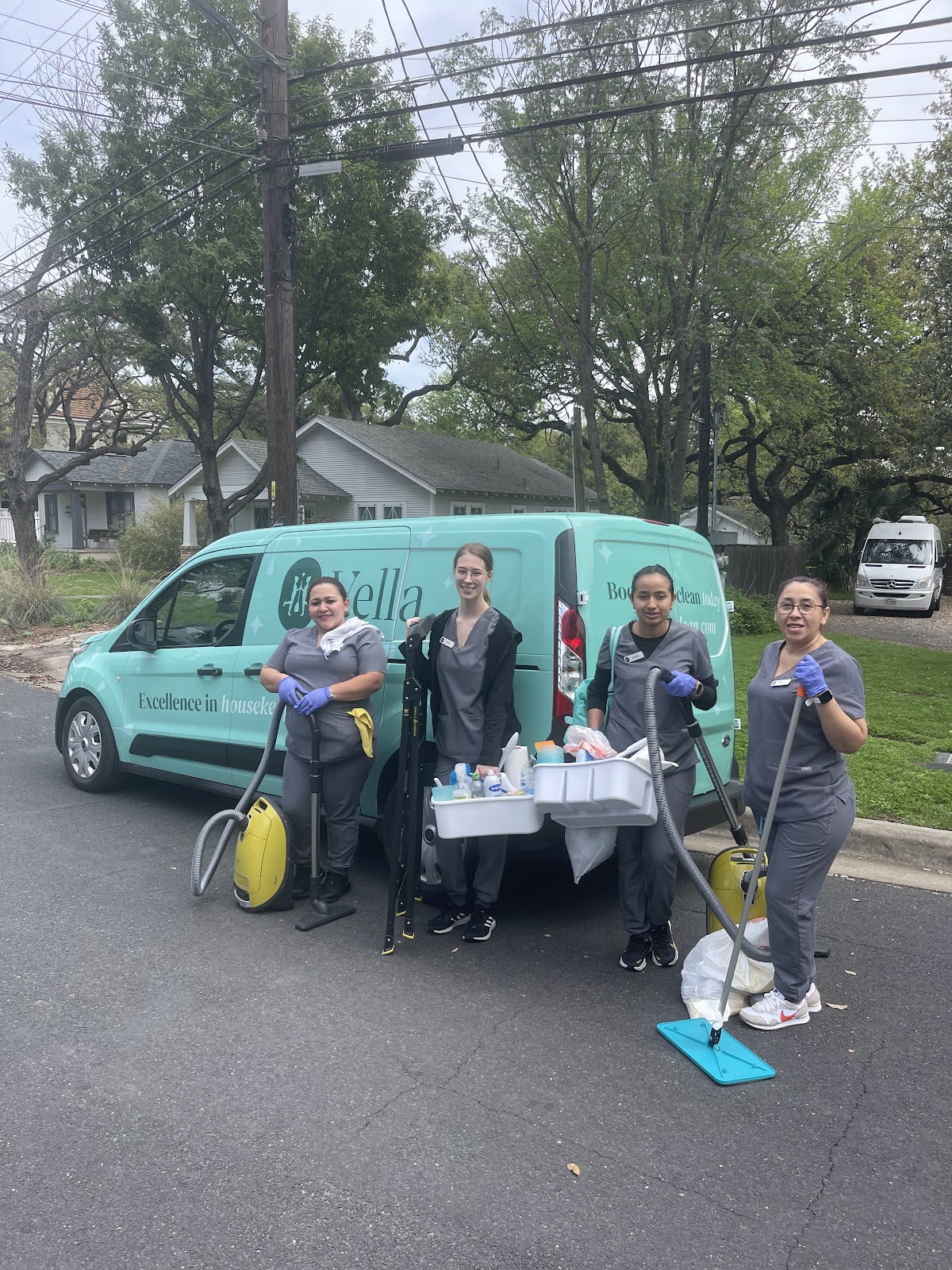 The Vella staff in front of the van with all cleaning products and equipements. 