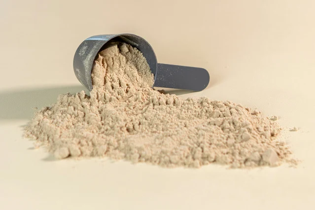 Protein powder spilled on a surface, showcasing the supplement for an active lifestyle.