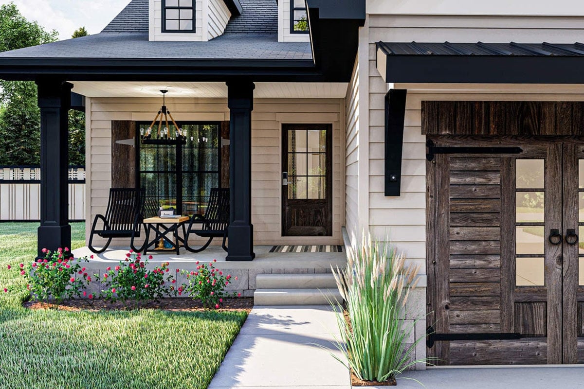 Entry porch with a concrete stoop framed with black columns.