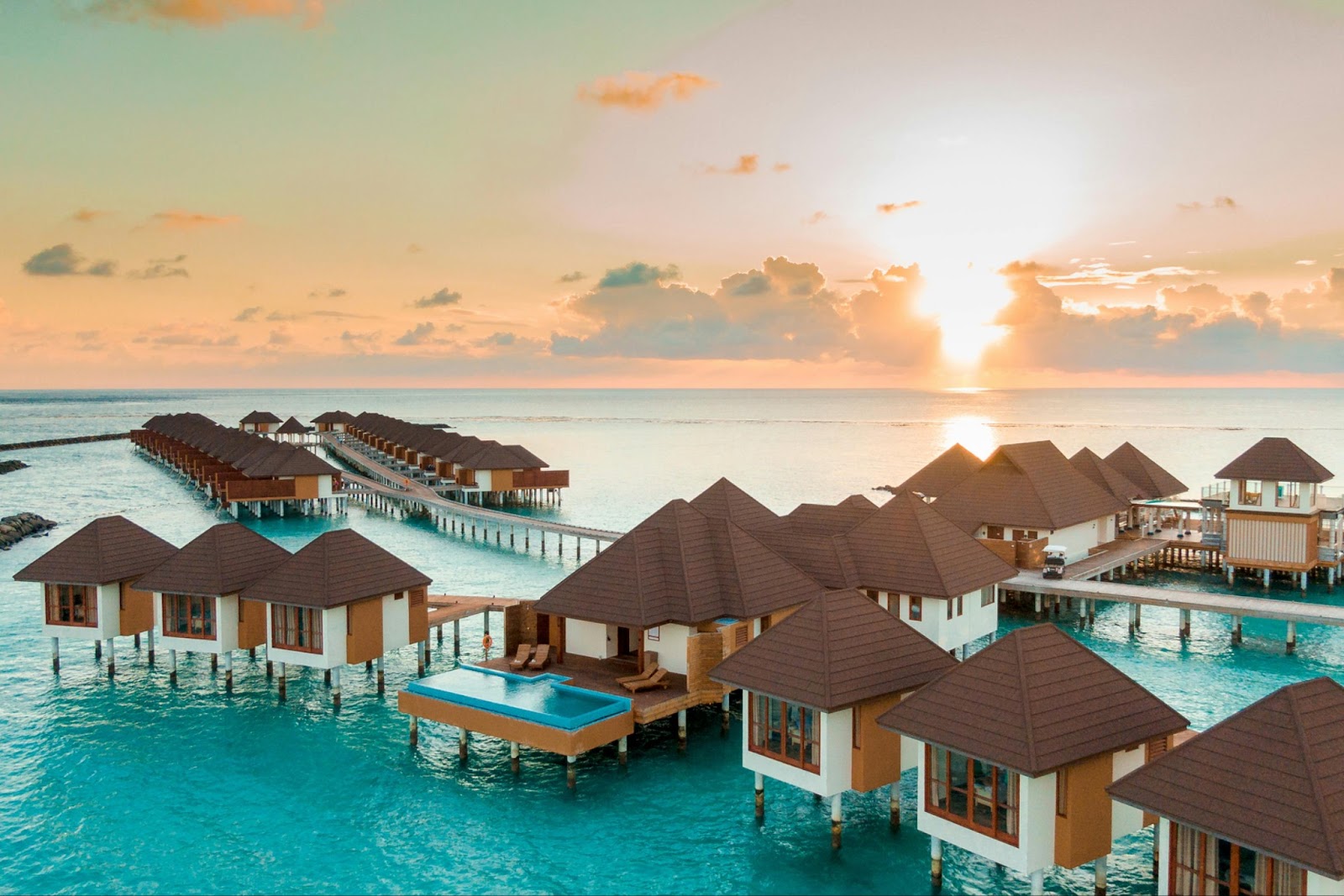 Luxury resorts in the Maldives with sunset, a popular destination for warmer weather, especially in Autumn. 