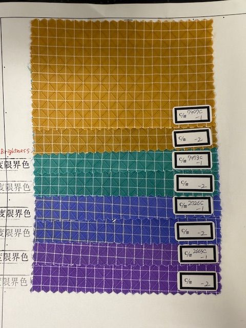 A collection of 200d Halcyon samples in mustard, green, indigo, and purple