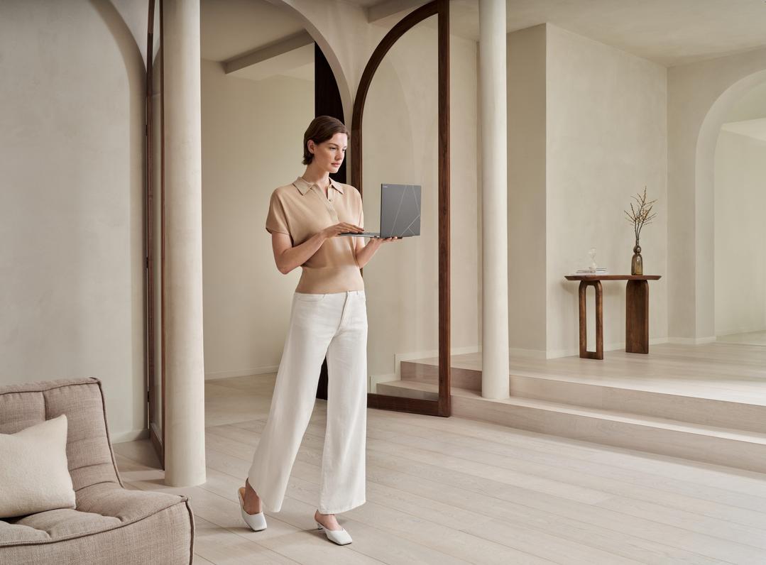 A person standing in a room with a computer