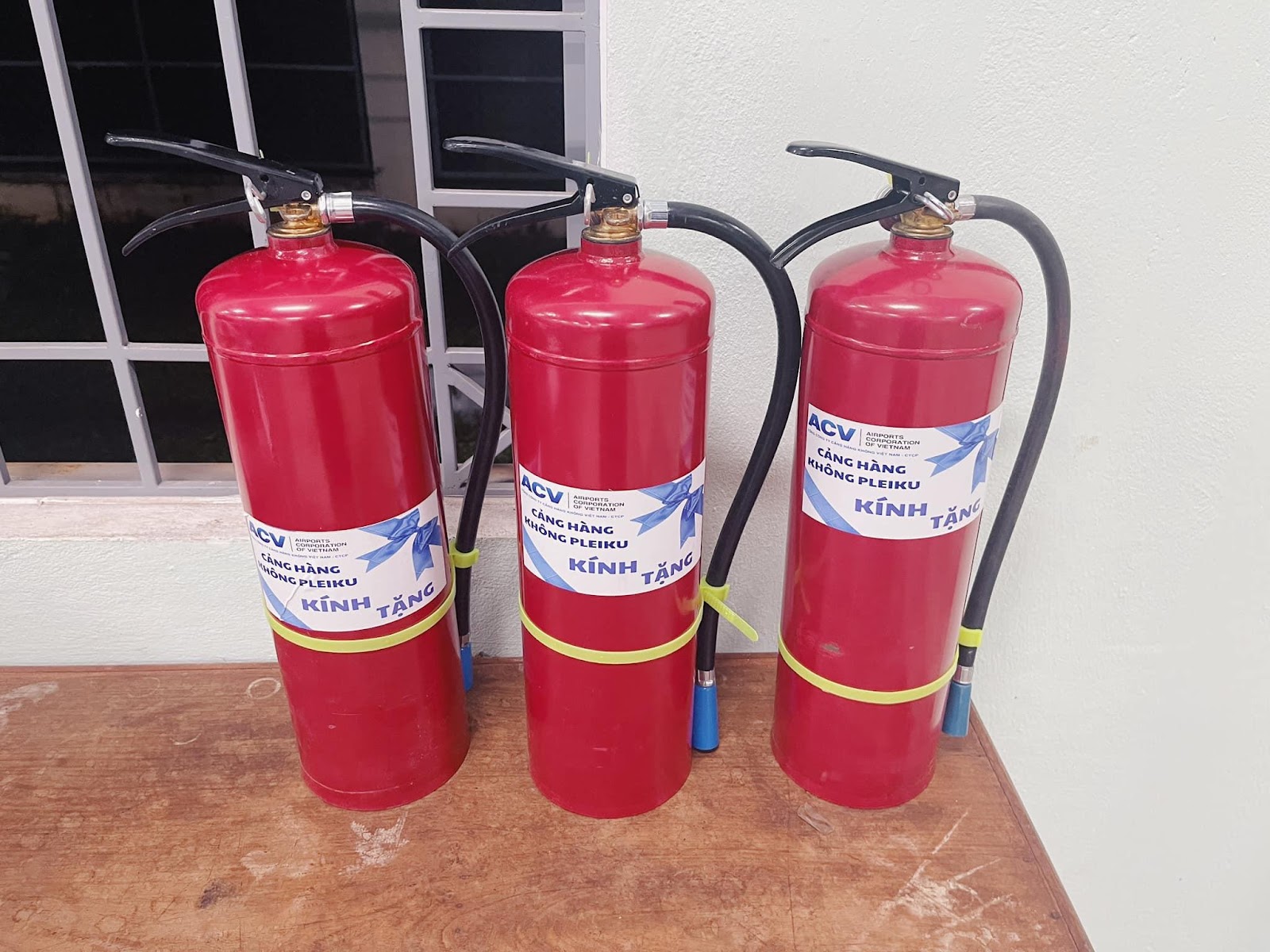 A group of fire extinguishersDescription automatically generated