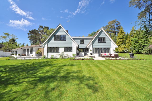 A house with a large front lawn.