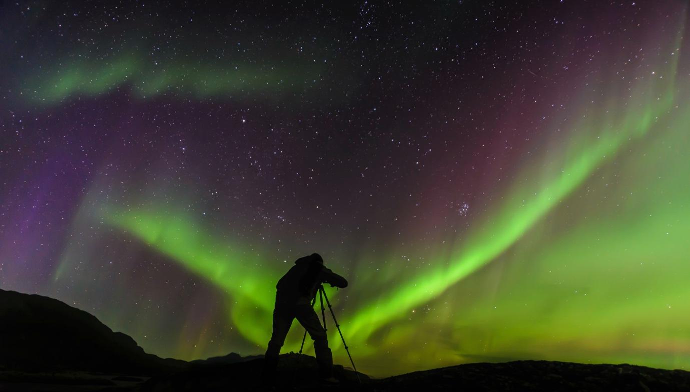 Silhouette of a Photographer Capturing the Northern Lights | Skylum Blog