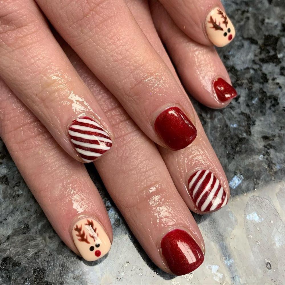 Close up of hands having Christmas red nails with Short Christmas Nails