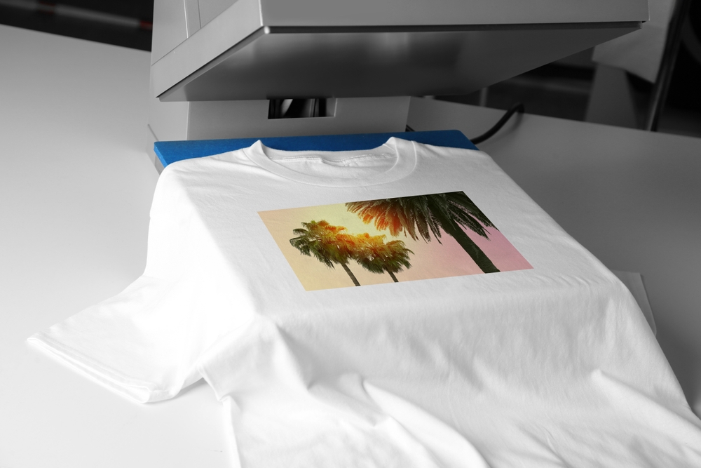 White T-shirt being printed with a heat press machine.