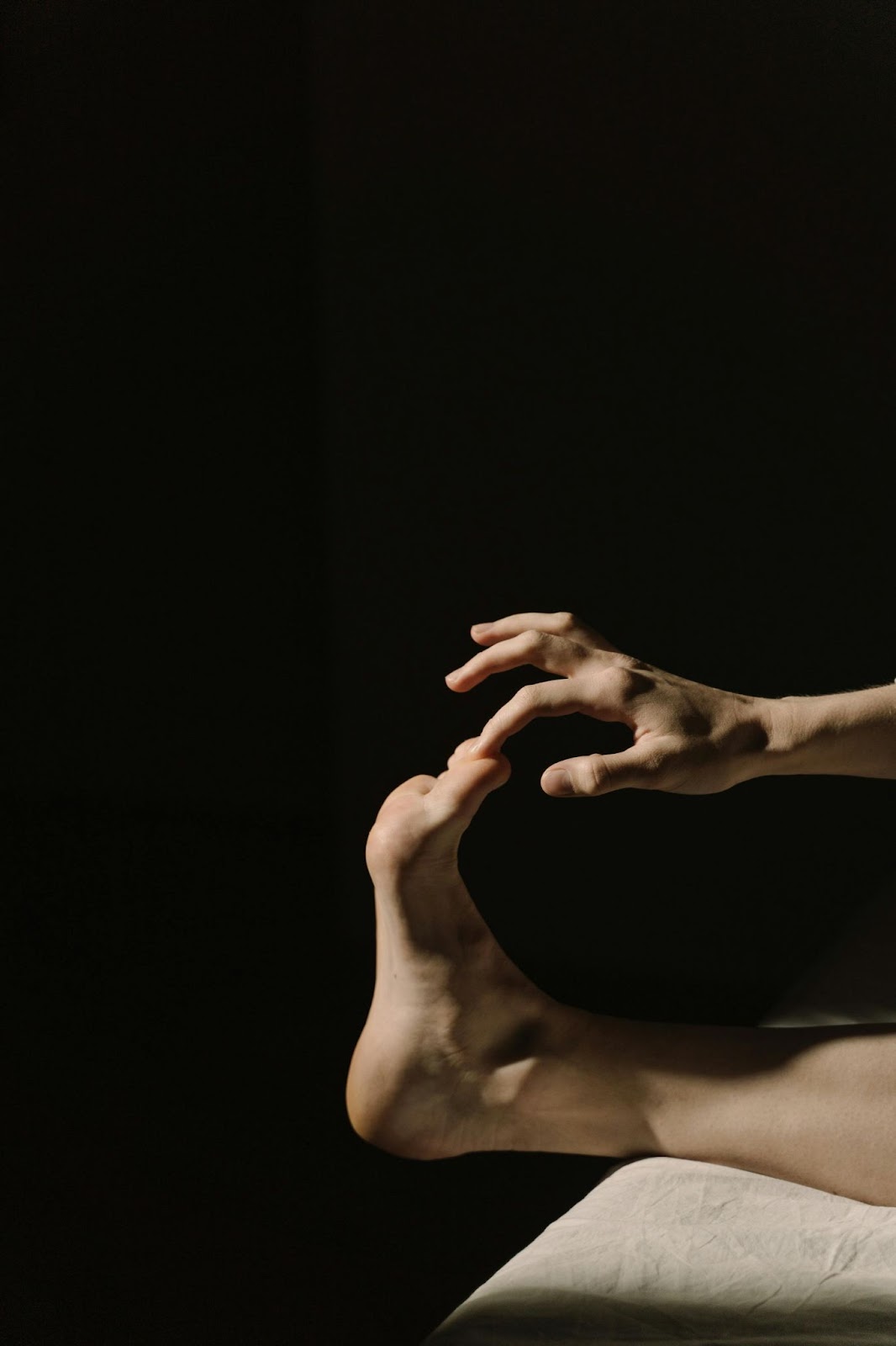 A close-up picture of a finger touching the big toe of a foot