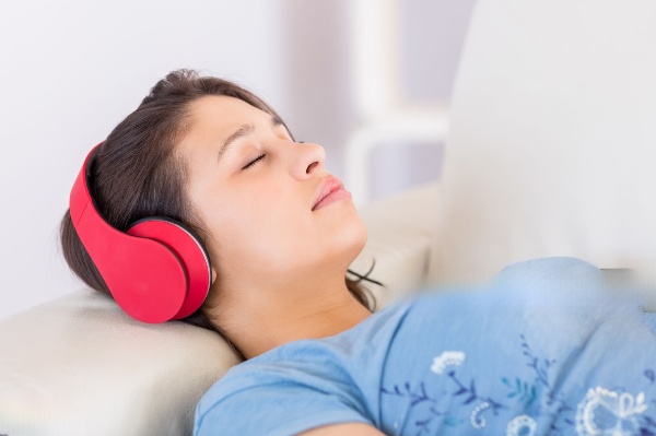 A woman lying comfortably with a cervical pillow supporting her neck