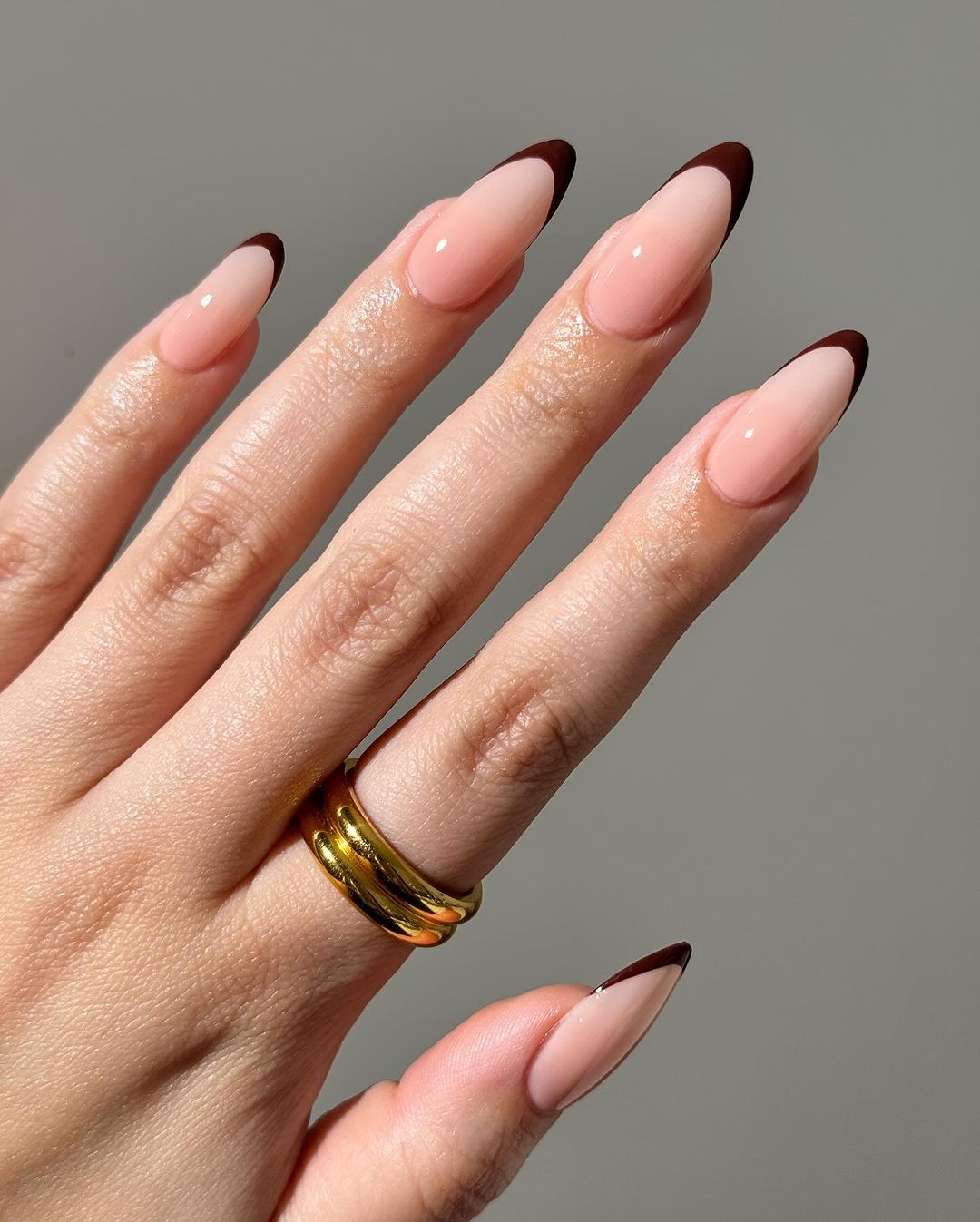 Close up of hands with brown French Nails