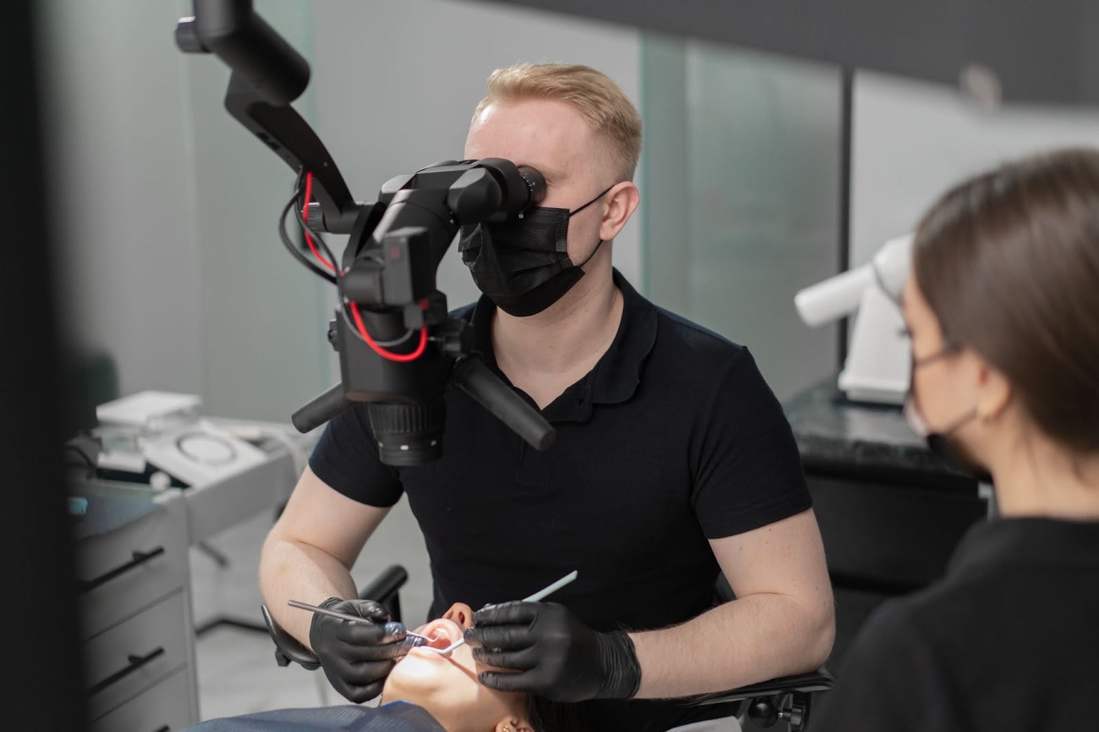 A dentist examines a patient through an advanced dental microscope while performing a precision procedure. This modern dental technology improves accuracy and enhances patient outcomes. Schedule your visit with a trusted dentist in Bradenton Florida for cutting-edge care.

