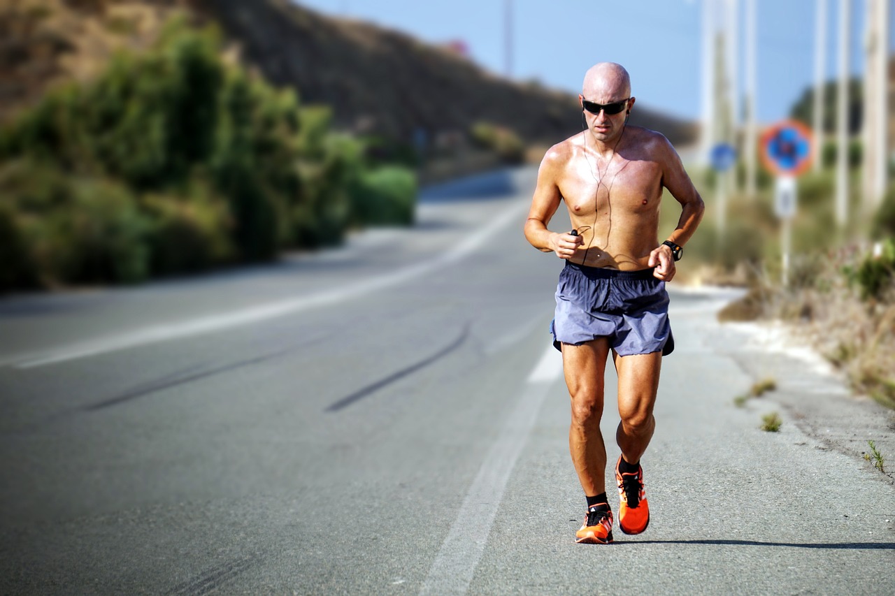 middle aged man running on a scenic paved road