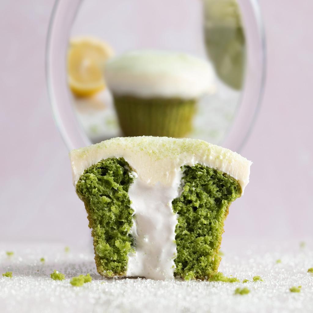 A cupcake with a white frosting Description automatically generated