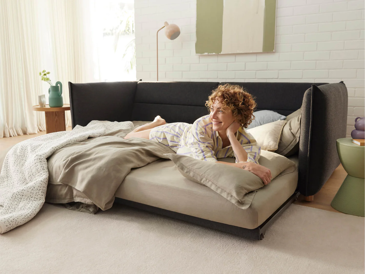 woman relaxing on sleeper sofa