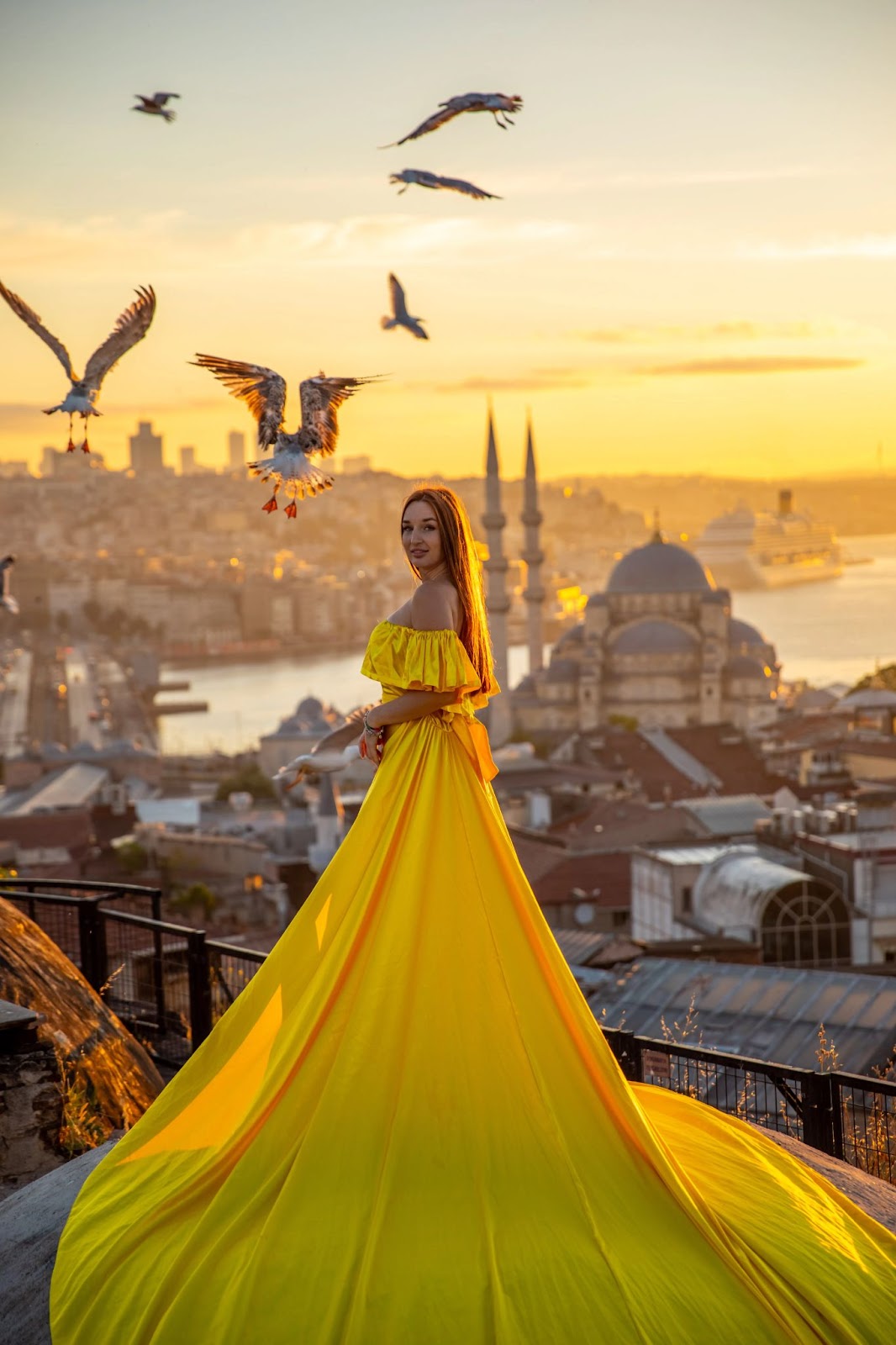 Lady on rooftop at golden hour, mosque skyline behind.