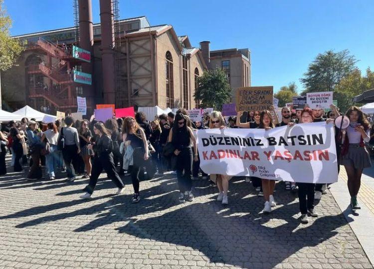 A group of people holding signsDescription automatically generated