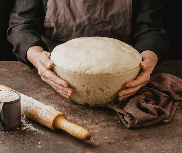 Chef making the dough for the delicious pizzas 