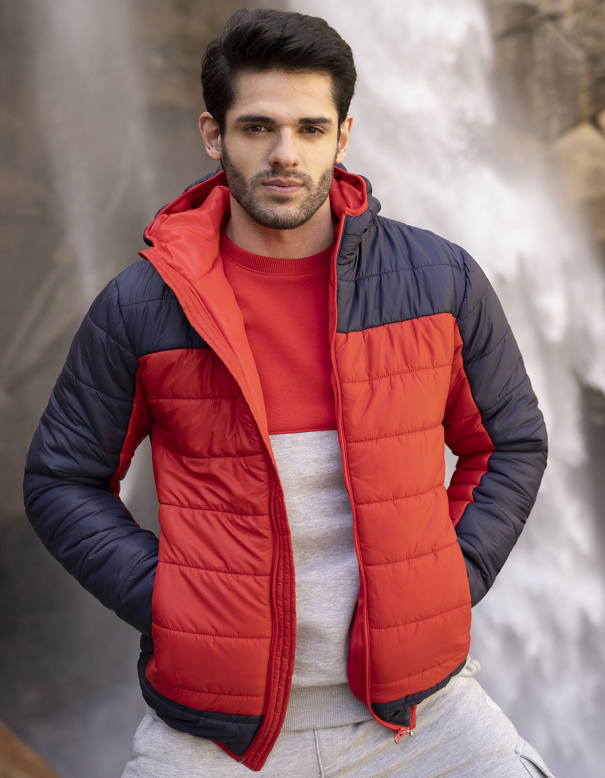 A remarkable puffer jacket in navy blue and orange color with full sleeves and zipper closure