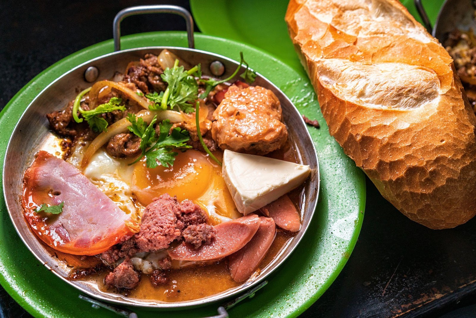 A plate of food next to a loaf of bread

Description automatically generated